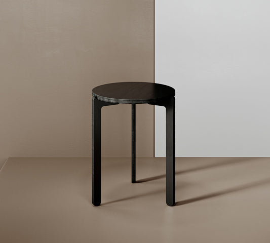 A black side table with a round base, providing a sleek and minimalist design.