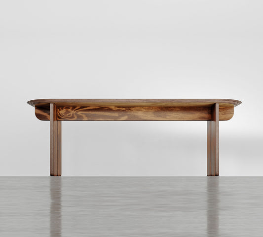 Bench made of wood with curved top.